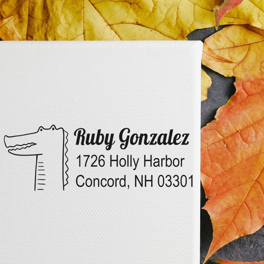 Custom rubber return address stamp with alligator logo for Ruby Gonzalez, 1726 Holly Harbor, Concord, NH 03301.
