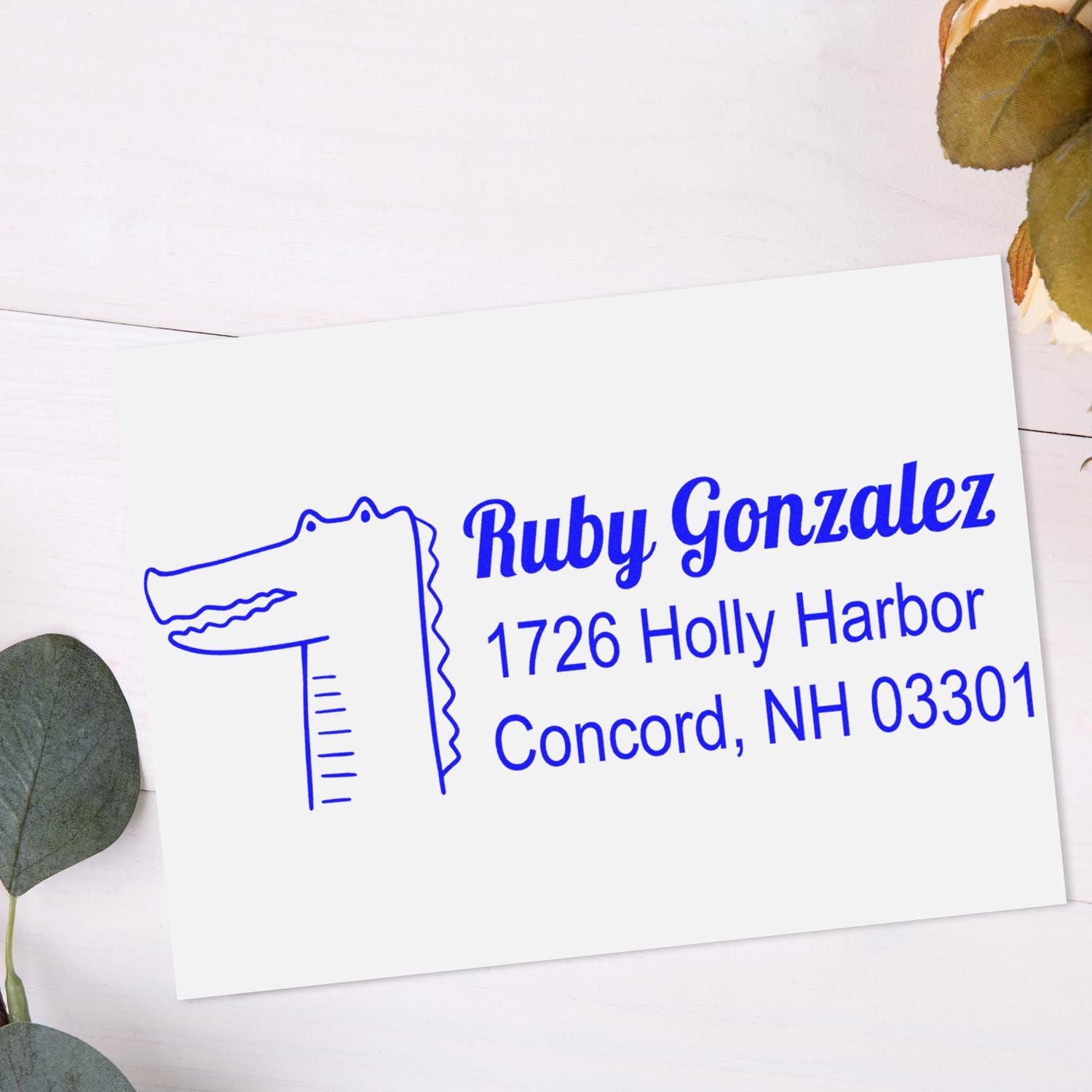 Custom address rubber stamp for Ruby Gonzalez, 1726 Holly Harbor, Concord, NH 03301, with alligator logo.