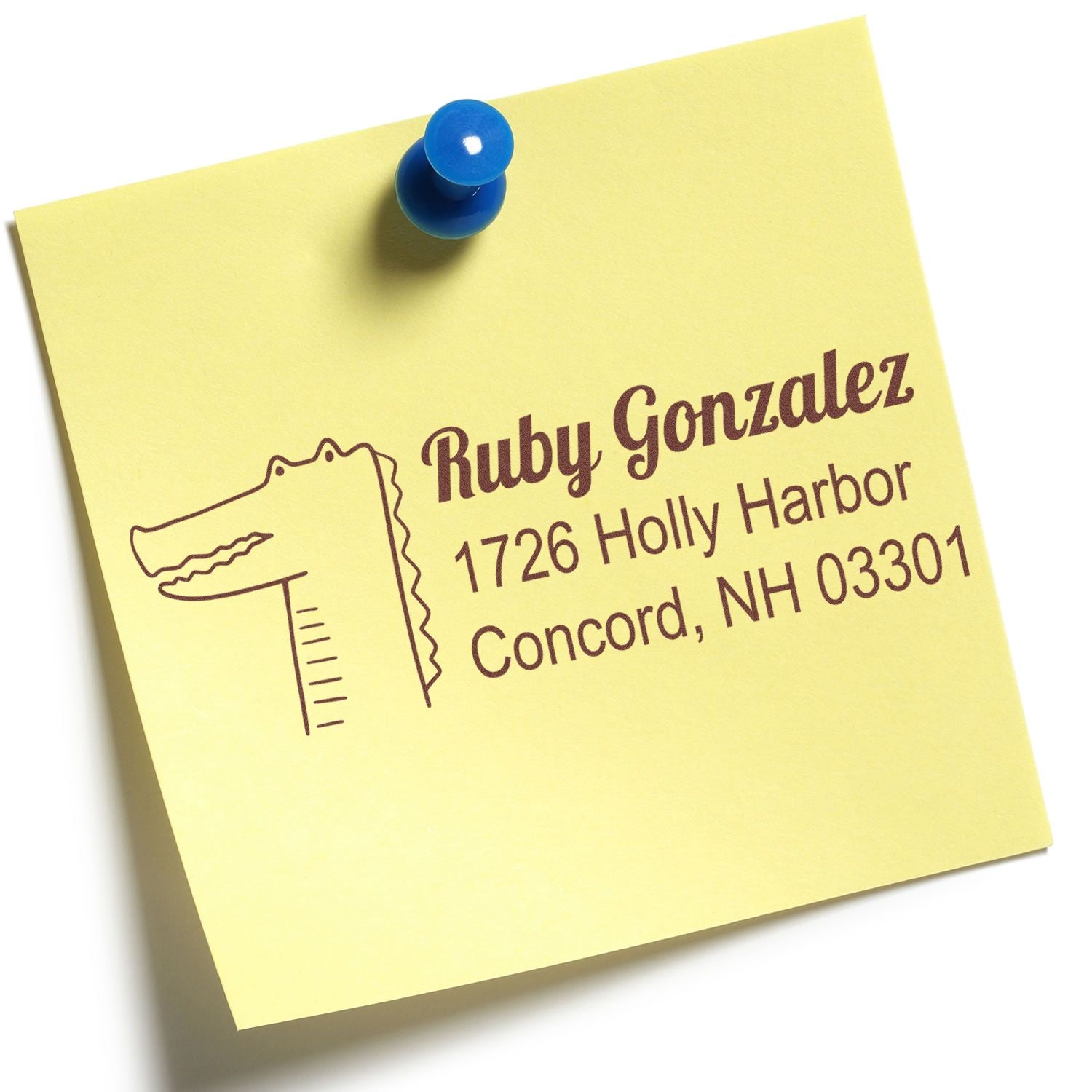 Personalized return address rubber stamp on yellow sticky note with alligator logo, Ruby Gonzalez name and address.