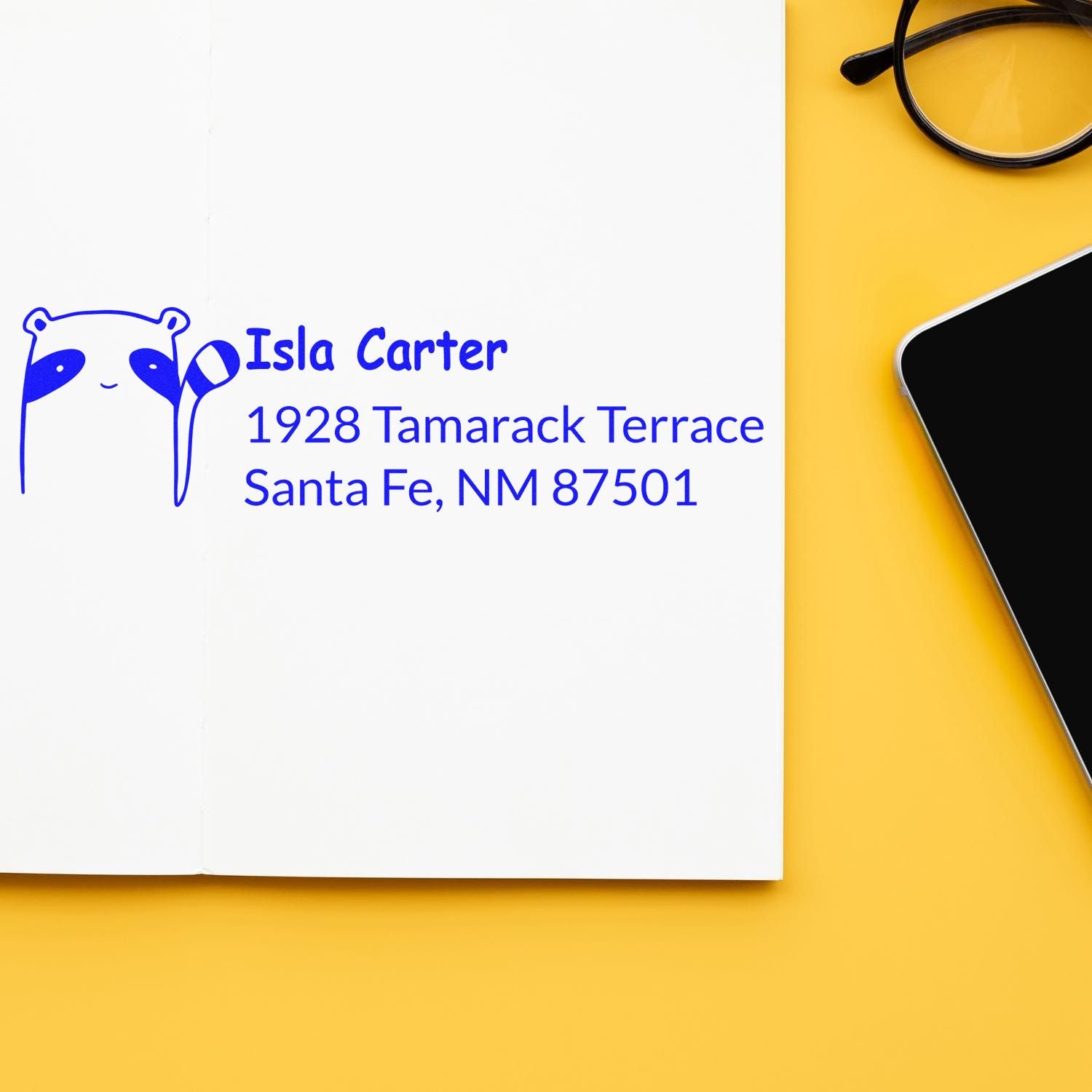 Personalized rubber return address stamp with raccoon design for Isla Carter, Santa Fe, NM.