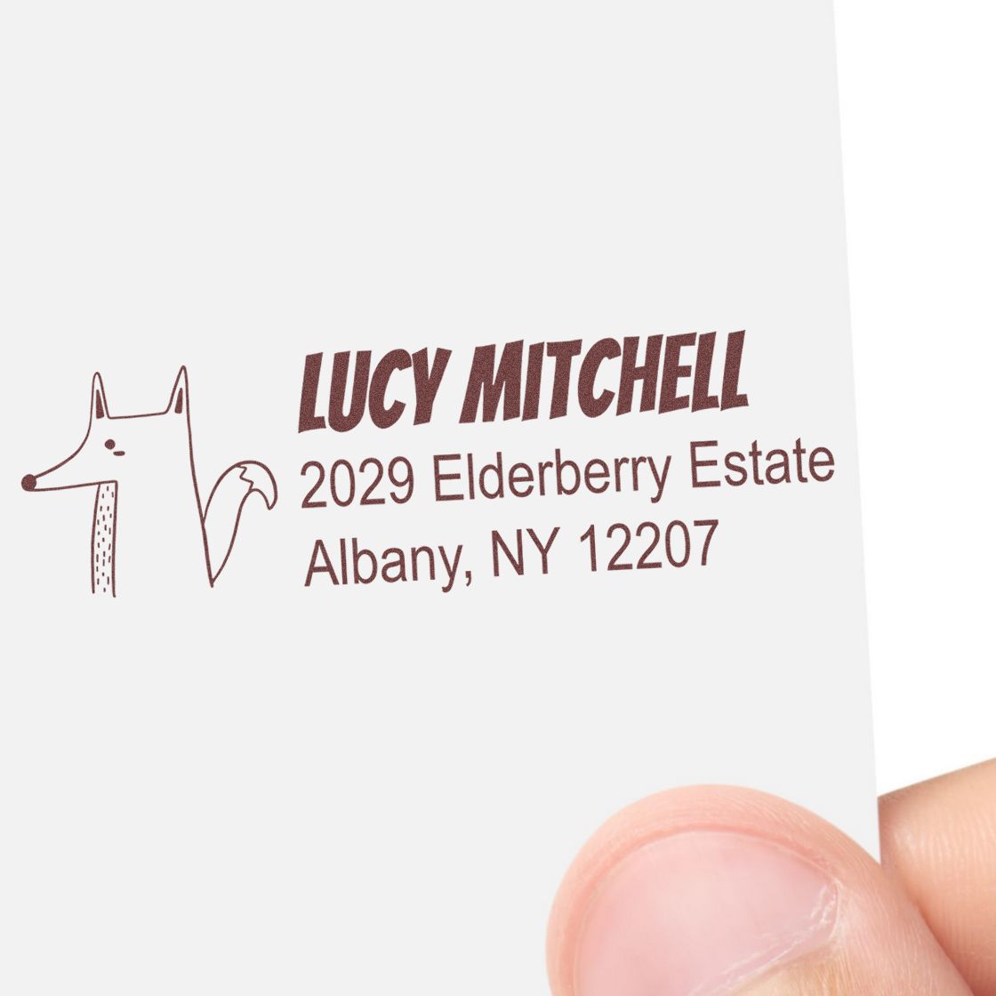 Custom rubber address stamp with fox design, featuring Lucy Mitchell, 2029 Elderberry Estate, Albany, NY 12207.