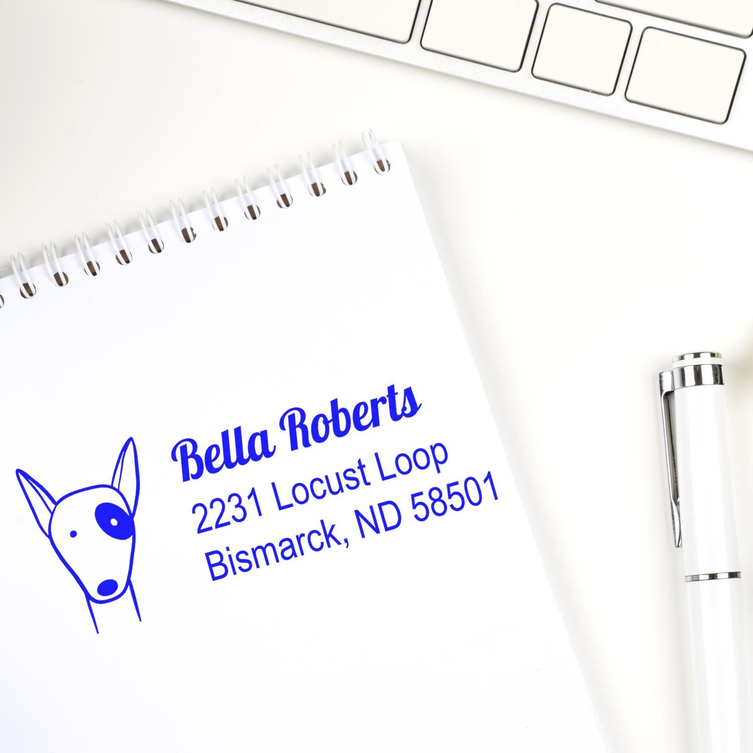 Custom address rubber stamp with dog logo for Bella Roberts, 2231 Locust Loop, Bismarck, ND 58501.