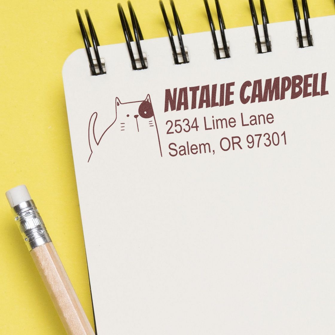 Custom cat return address rubber stamp on notebook page with personalized name and Salem, OR mailing address.