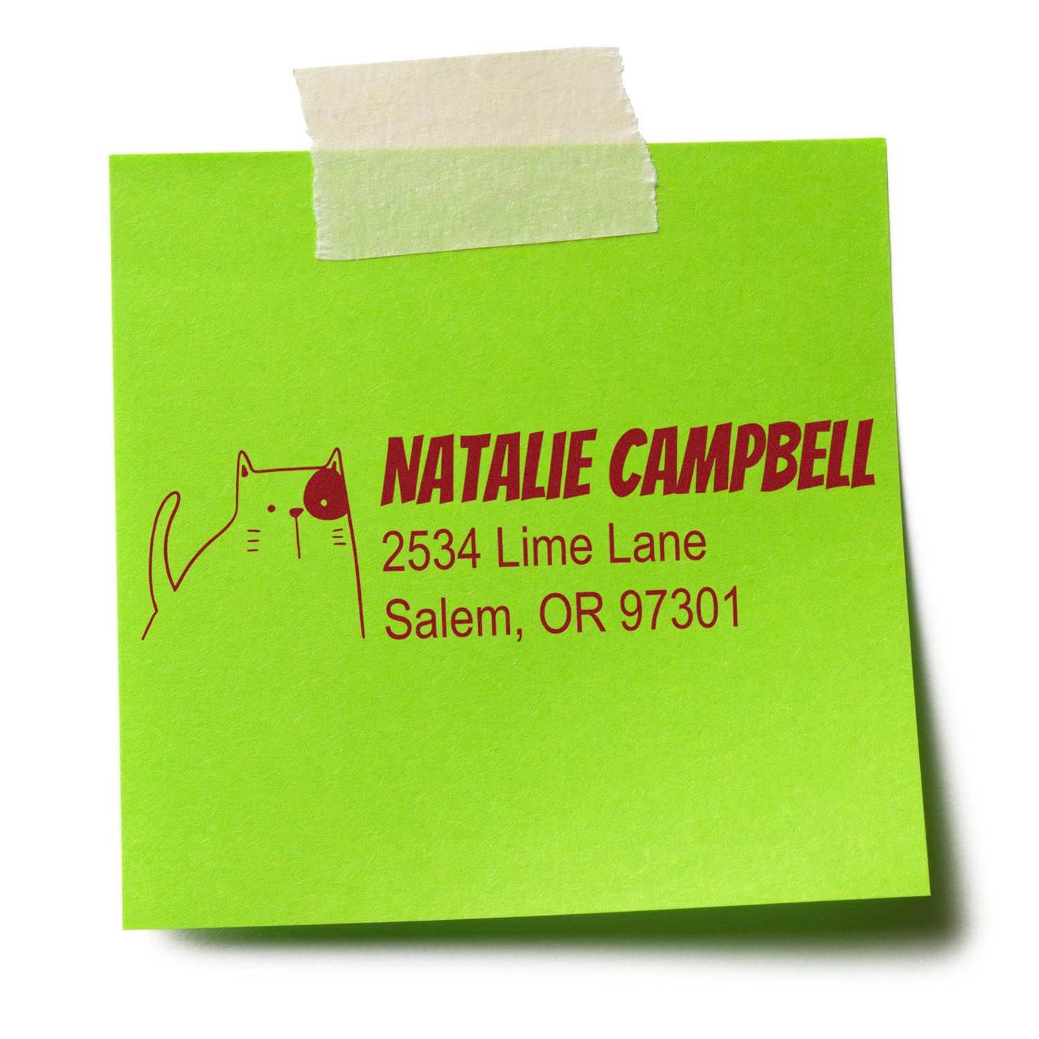 Custom return address rubber stamp with cat design for Natalie Campbell on a green sticky note.