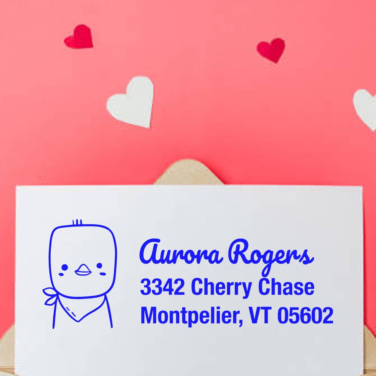 Custom rubber address stamp with cute character design for Aurora Rogers, Montpelier, VT 05602 on a Valentine envelope.