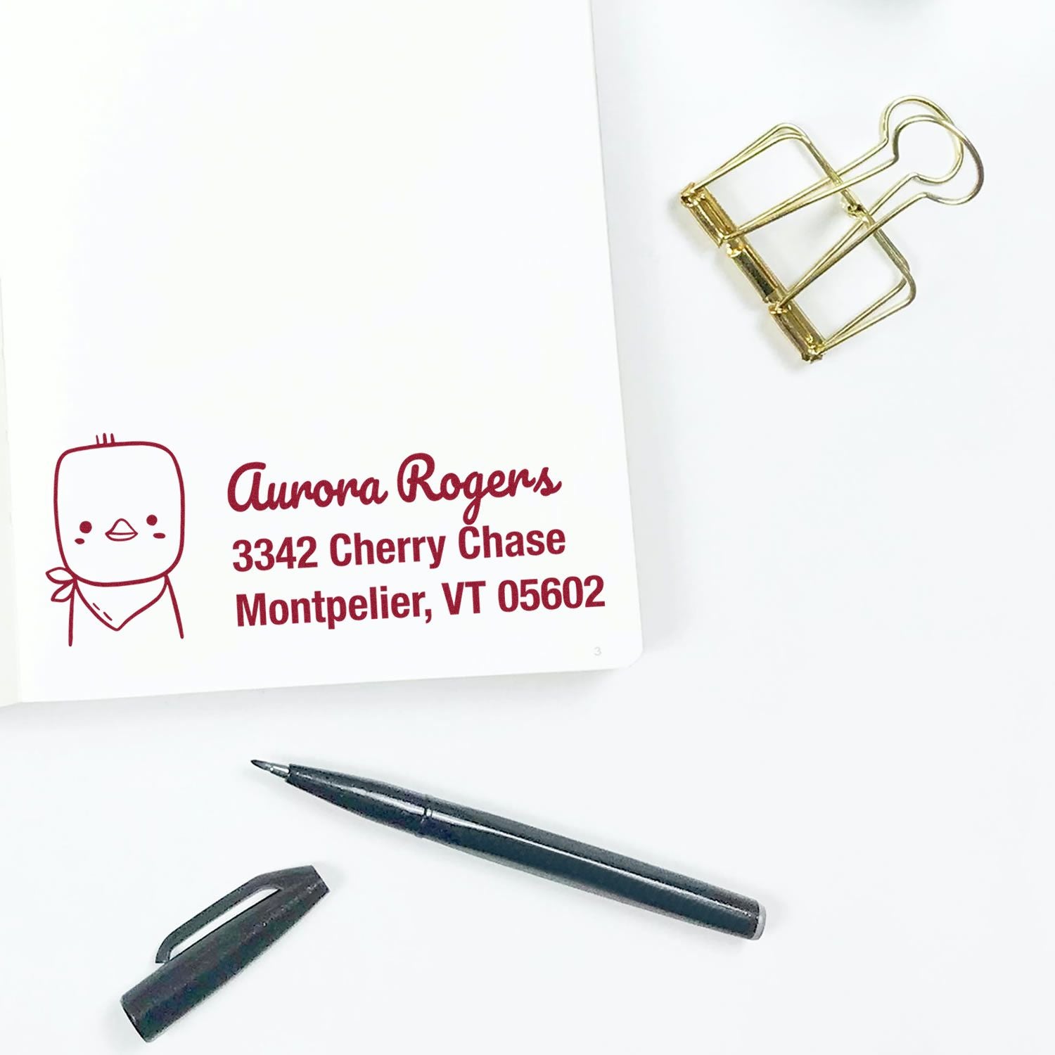 Personalized return address rubber stamp impression with cute character and Aurora Rogers, Montpelier, VT address.