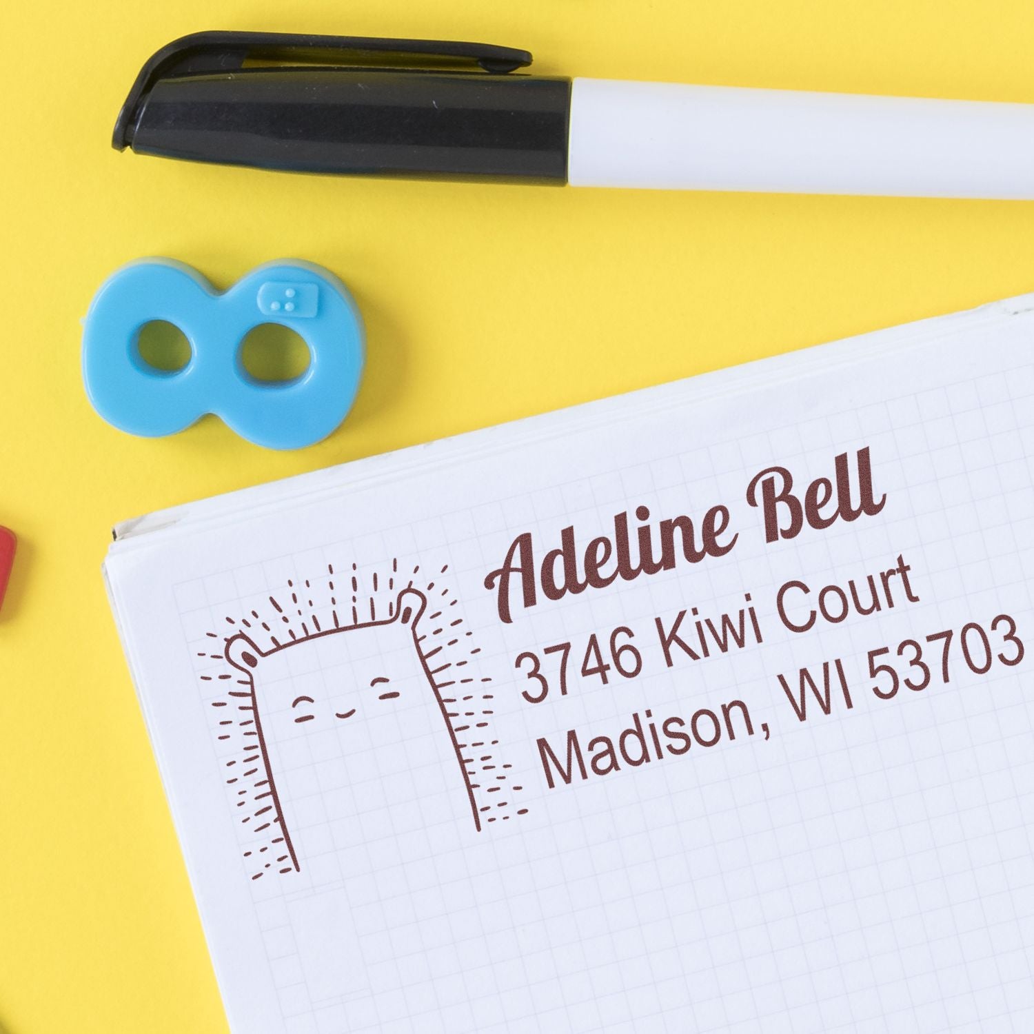 Personalized address rubber stamp with name and address on notebook, ideal for mailing, return addresses, and labels.