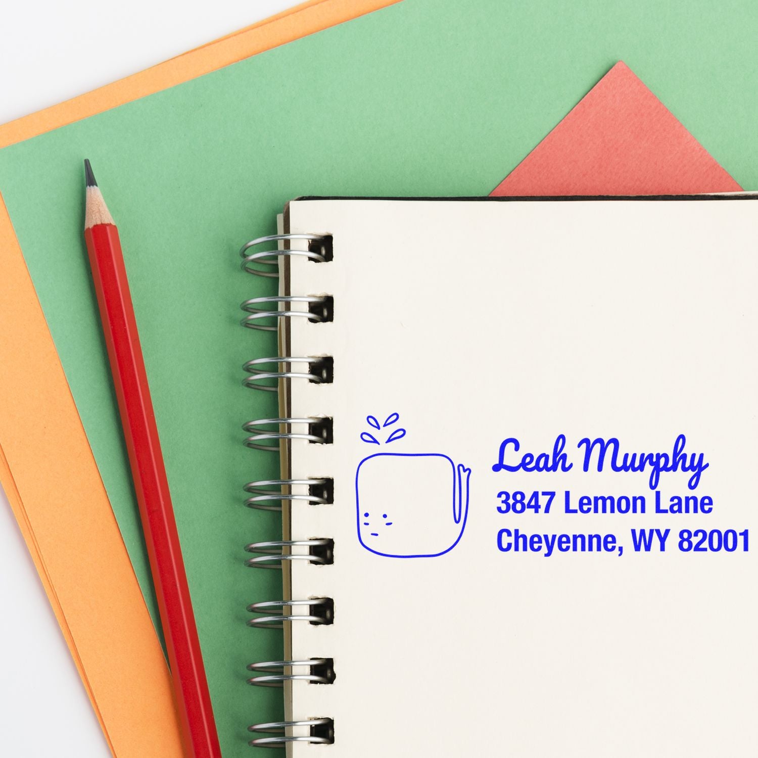 Custom return address rubber stamp on notebook for personalized stationery, featuring Leah Murphy, Cheyenne, WY.