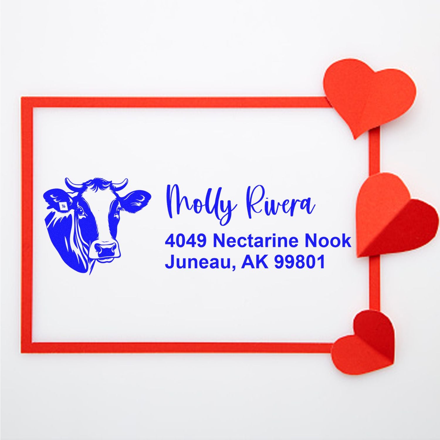 Custom cow return address rubber stamp for Molly Rivera, Juneau, AK 99801, with heart border for personalized mailing.