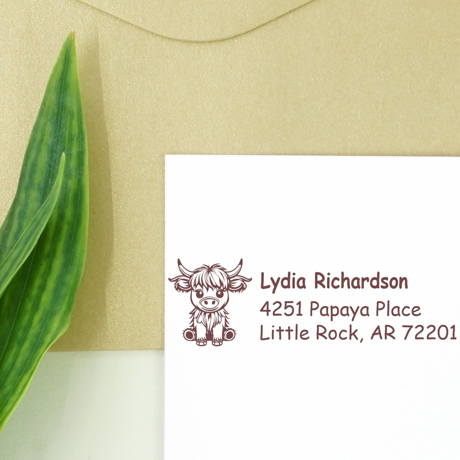 Custom cow return address rubber stamp with Lydia Richardson, Little Rock, AR address on white envelope