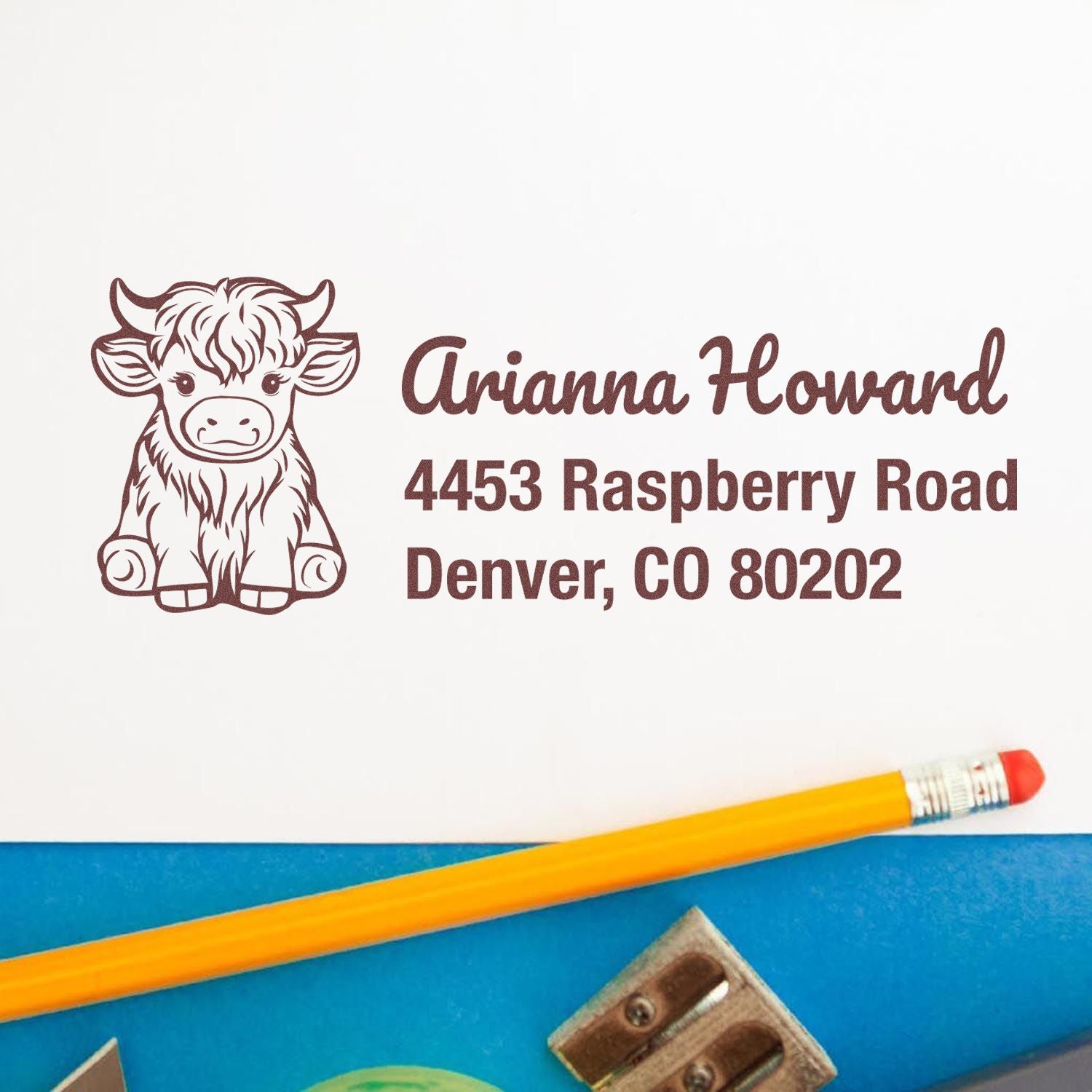 Custom cow address rubber stamp with name and Denver, CO mailing details for personalized stationery and packaging