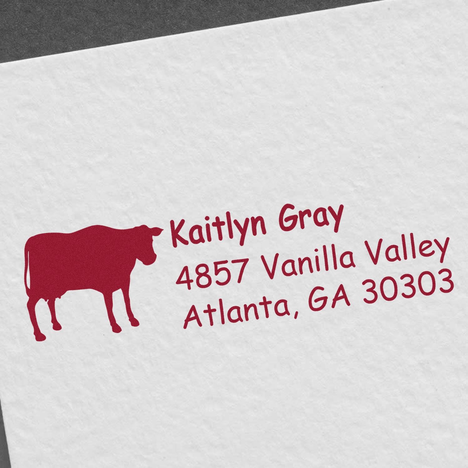 Personalized cow return address rubber stamp with Kaitlyn Gray, 4857 Vanilla Valley, Atlanta, GA 30303.