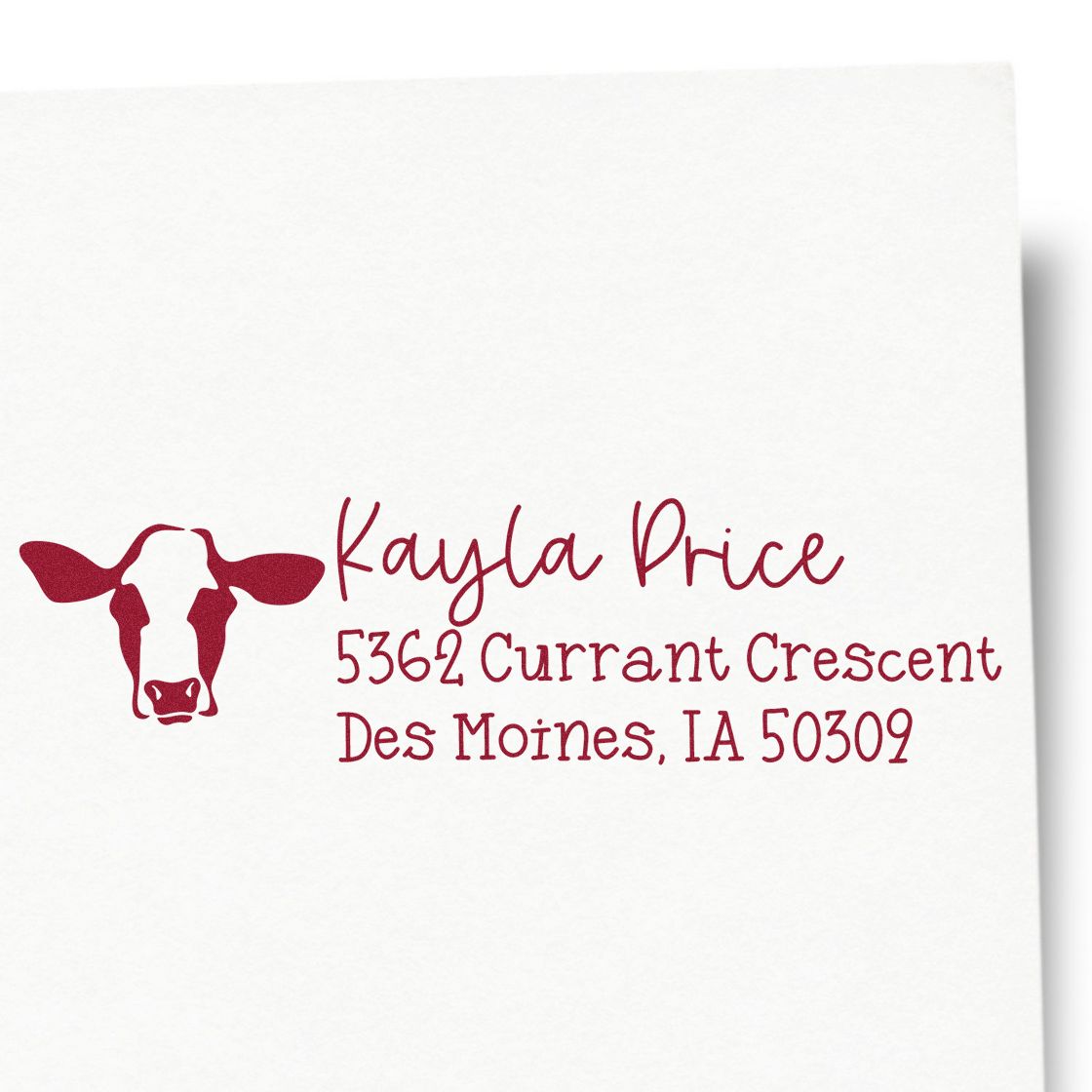 Personalized cow logo return address rubber stamp for Kayla Price, 5362 Currant Crescent, Des Moines, IA 50309.