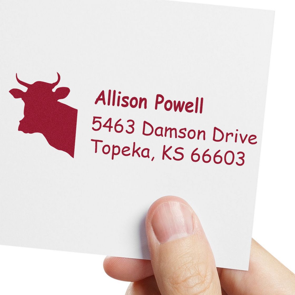 Custom rubber address stamp with cow silhouette and red ink for Allison Powell, 5463 Damson Drive, Topeka, KS 66603.
