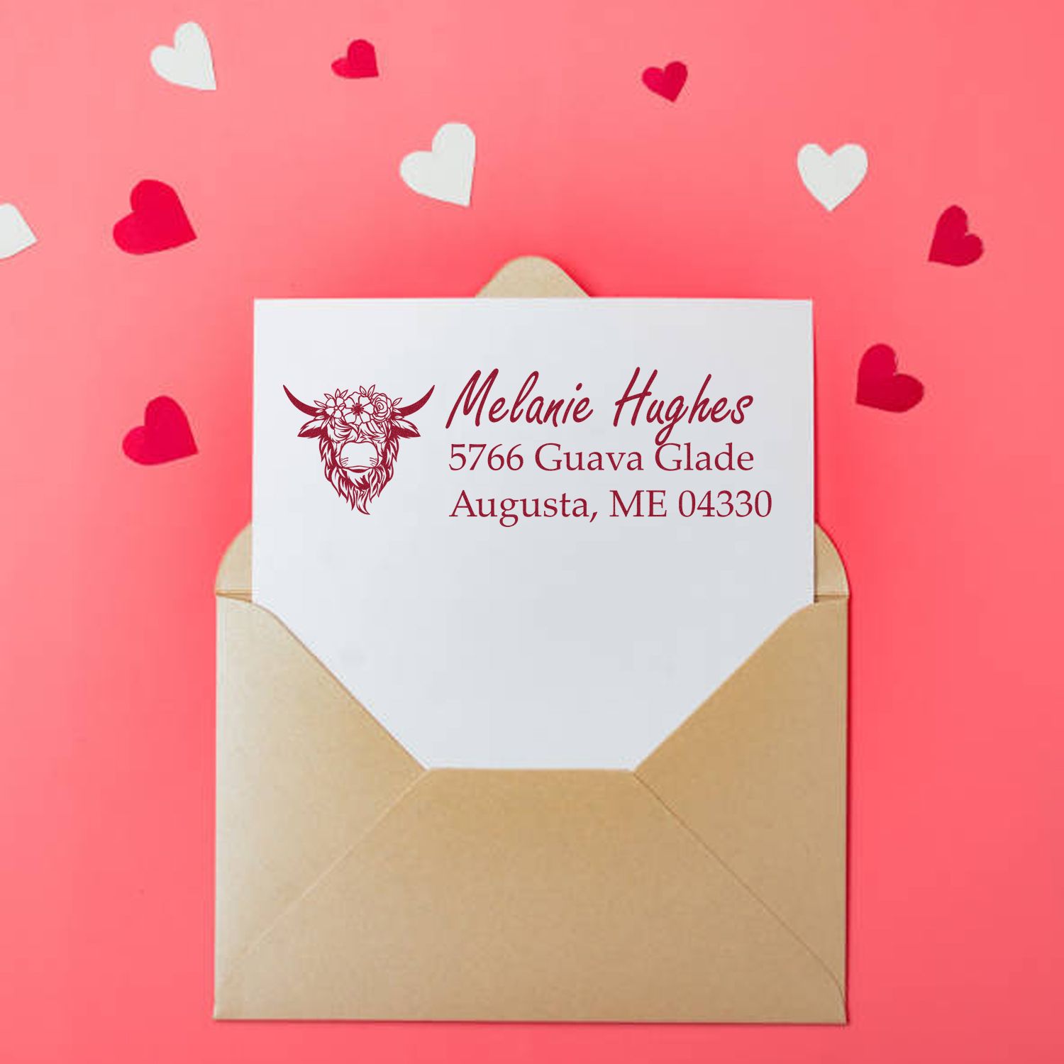Custom return address rubber stamp on envelope, featuring floral cow logo and personalized name and address for mailing.