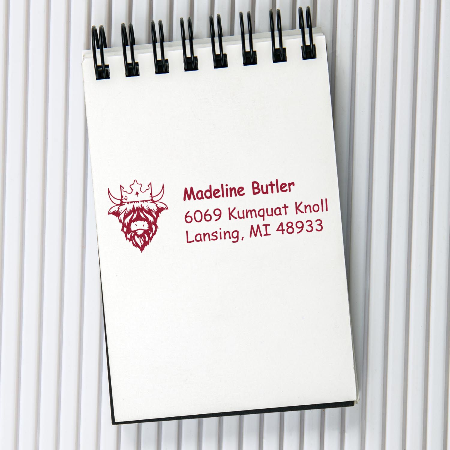 Custom return address rubber stamp with cow logo for personalized mailing envelopes and labels.