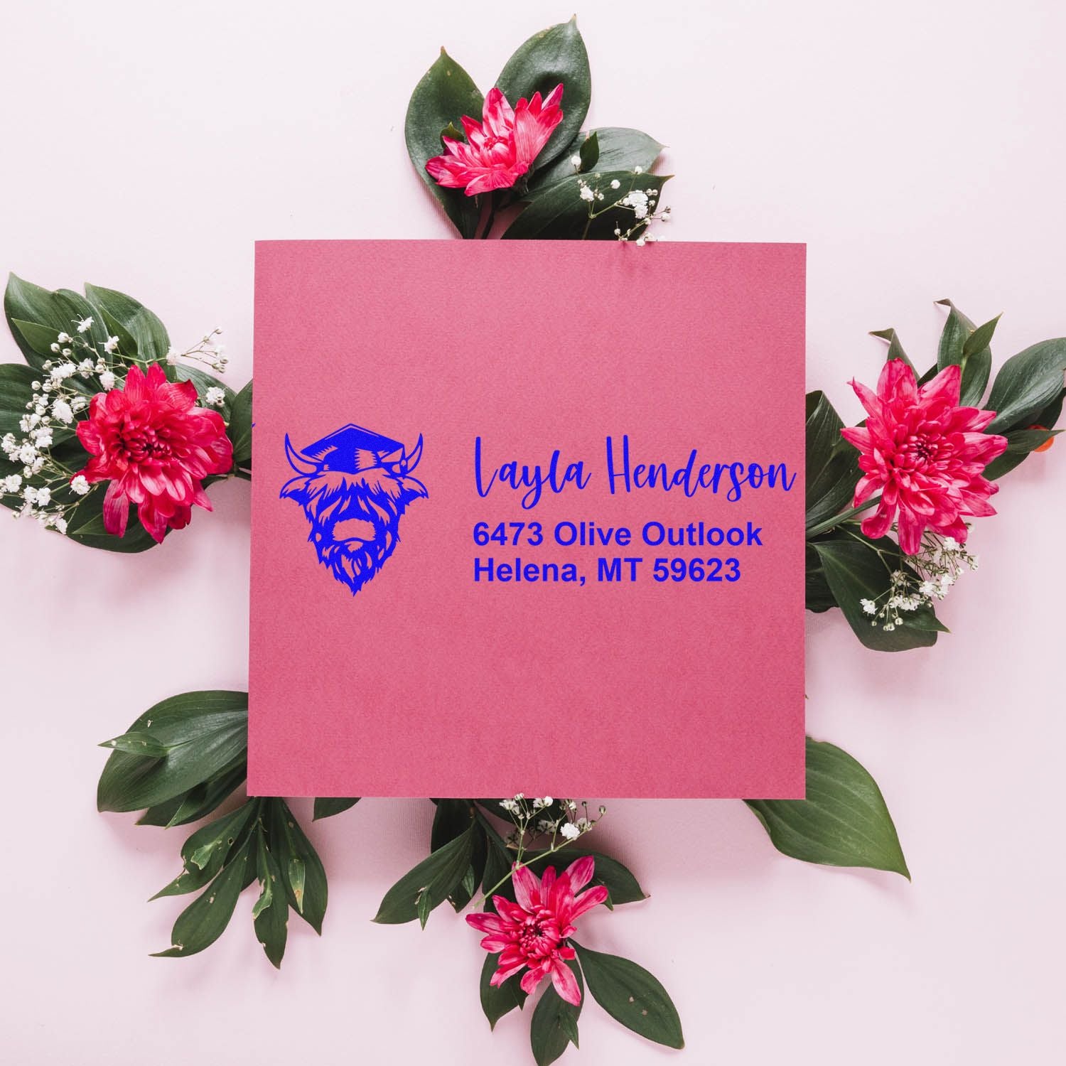 Custom rubber return address stamp with bison logo on pink envelope for personalized stationery.