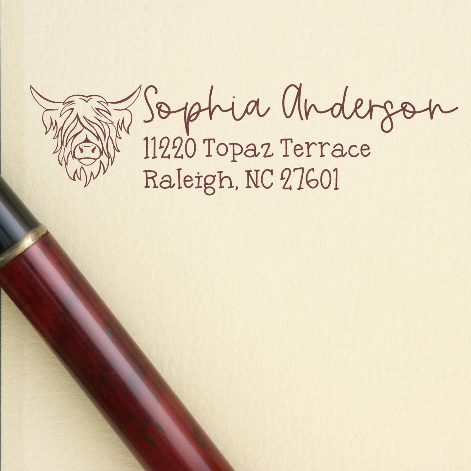 Highland cow return address rubber stamp for Sophia Anderson, Raleigh, NC 27601.
