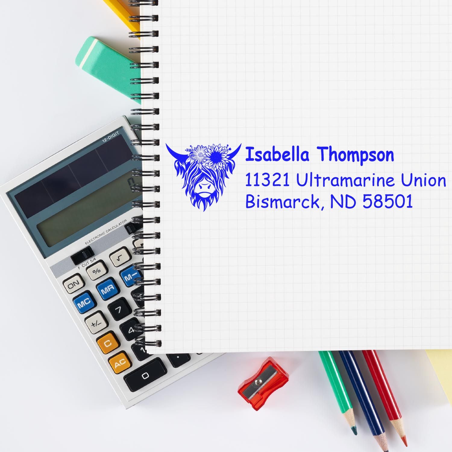 Custom rubber address stamp with name and Bismarck, ND address, shown on a stationery and calculator background.