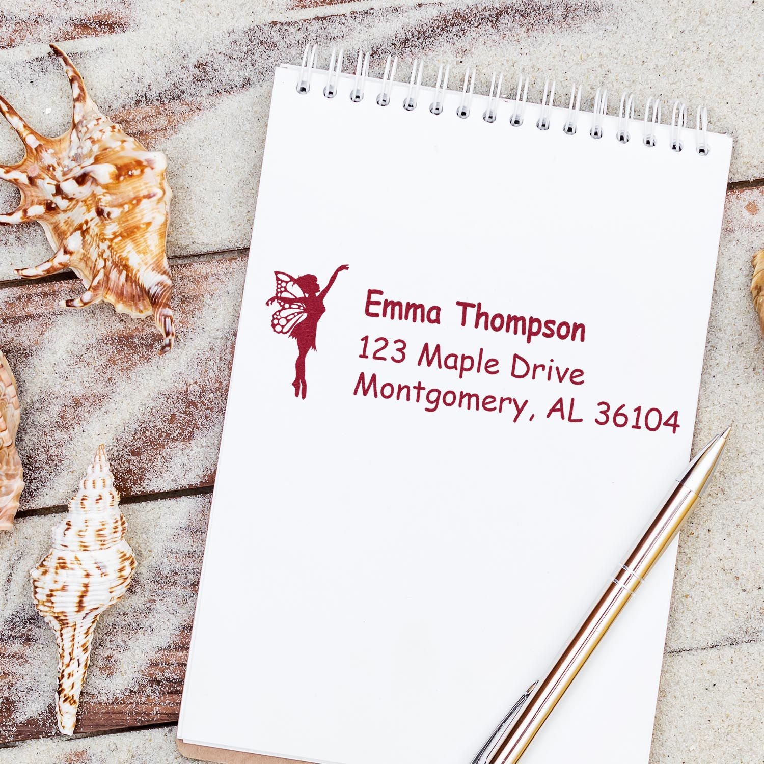Custom return address rubber stamp with fairy design on a notebook, ideal for personalized stationery and mailing.