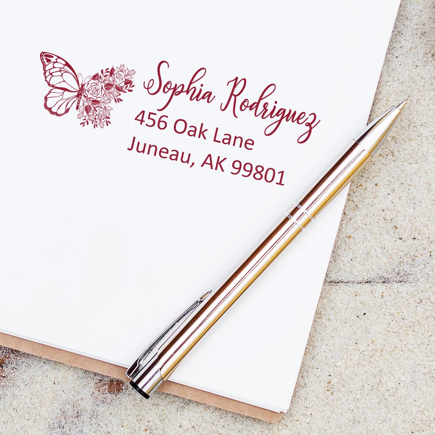 Custom butterfly floral return address rubber stamp for Sophia Rodriguez, Juneau, AK 99801.