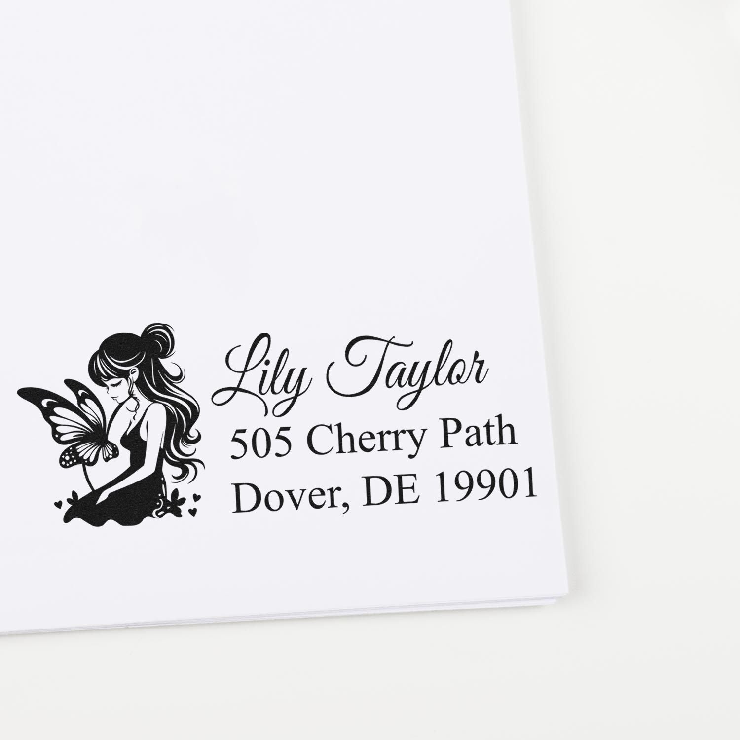 Custom return address rubber stamp with fairy and butterfly design for Lily Taylor, Dover, DE 19901.