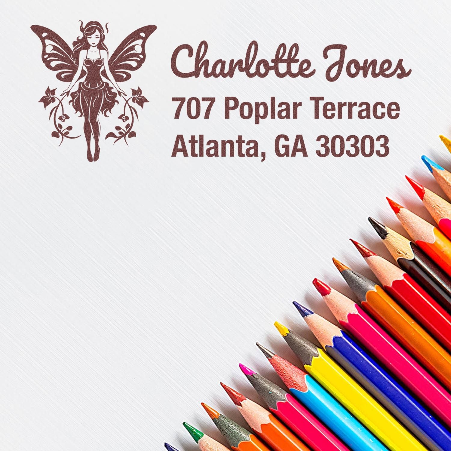 Custom fairy logo address rubber stamp for Charlotte Jones, 707 Poplar Terrace, Atlanta, GA 30303.
