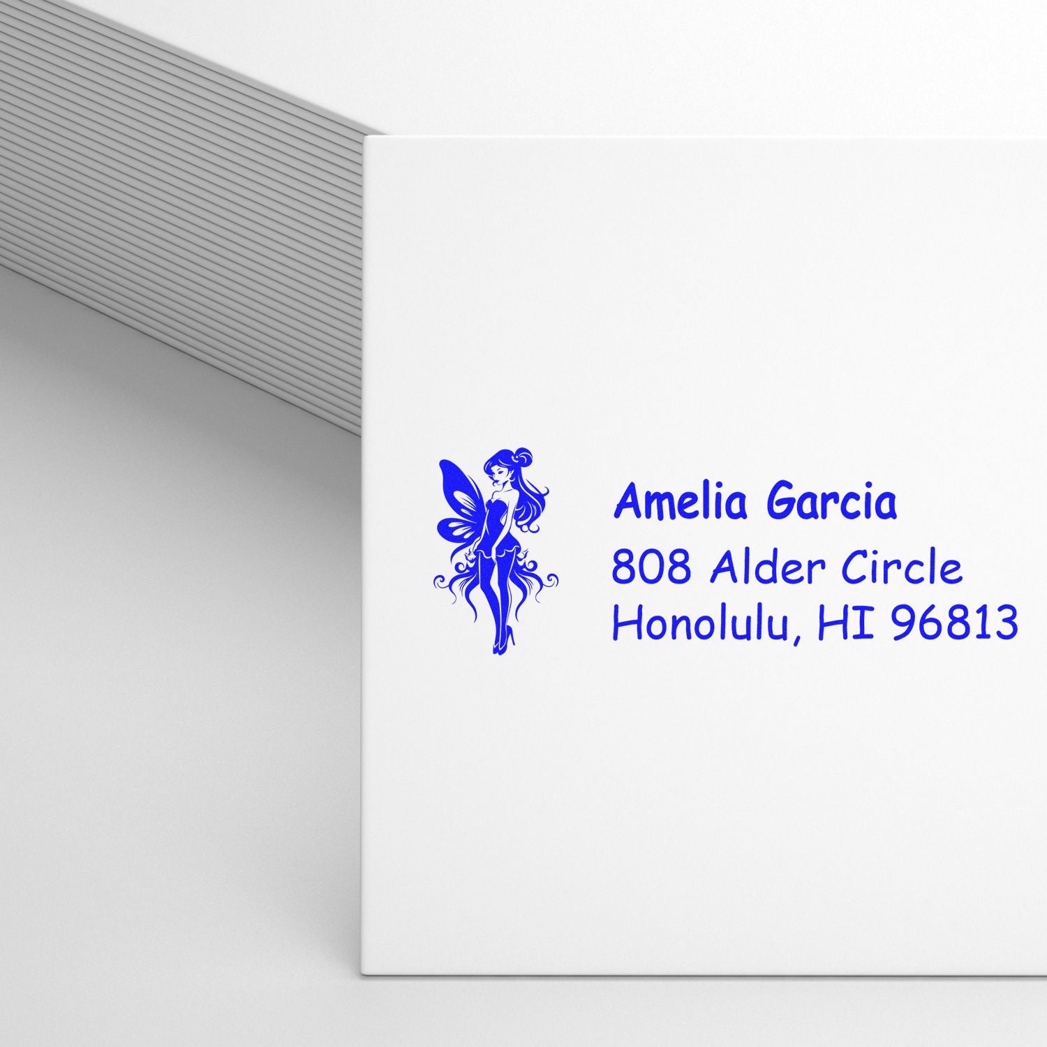 Custom return address rubber stamp with fairy design for Amelia Garcia, Honolulu, HI 96813.