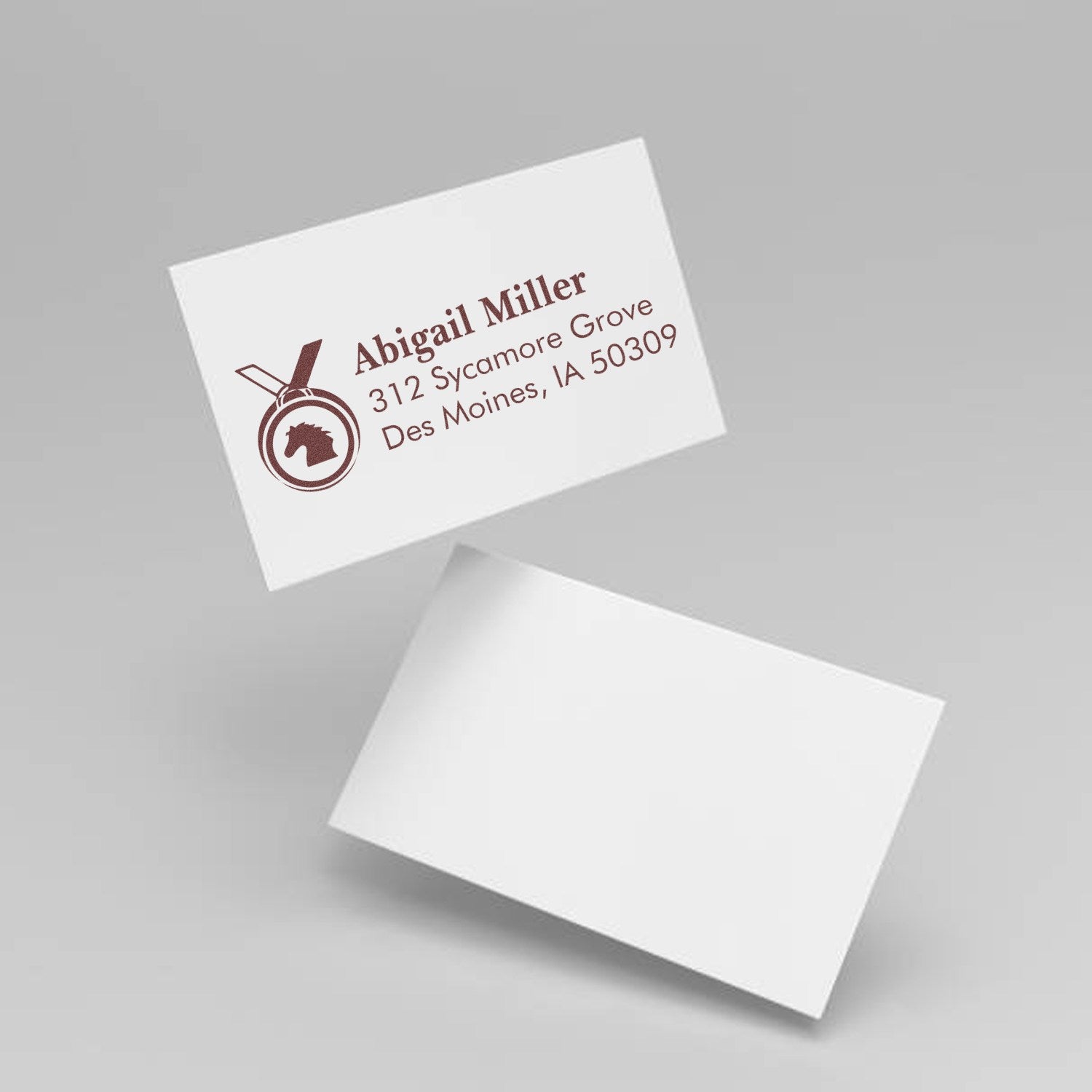 Custom horse logo return address rubber stamp mockup on business cards for Abigail Miller, Des Moines, Iowa