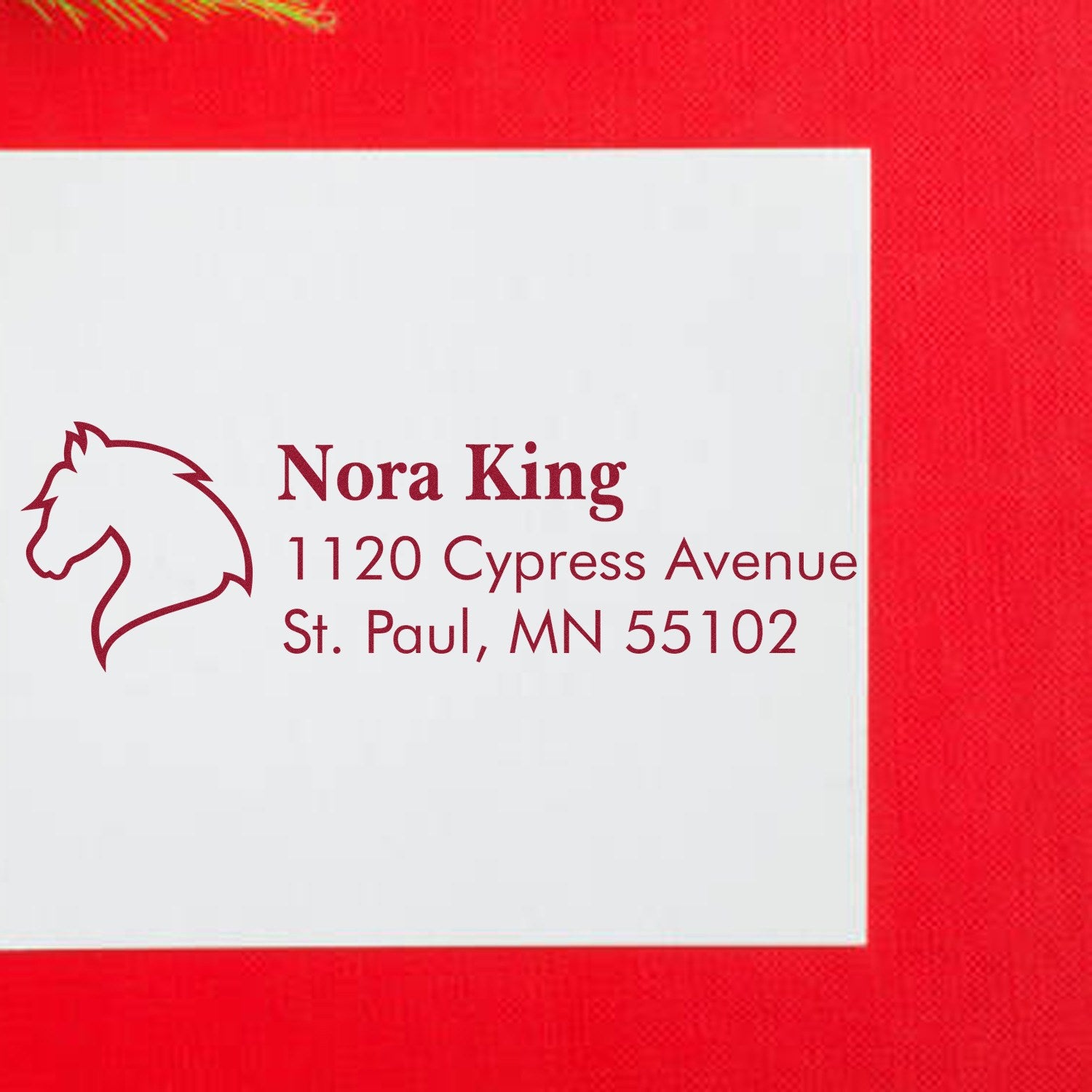 Custom rubber address stamp with horse logo for Nora King, 1120 Cypress Avenue, St. Paul, MN 55102