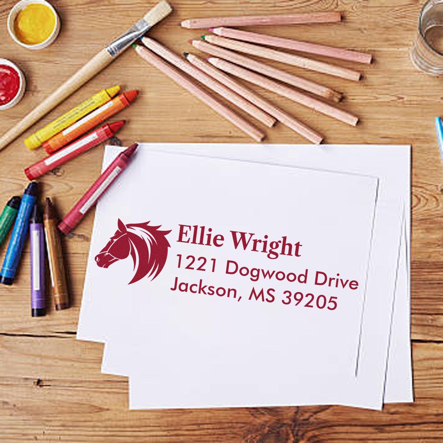 Custom address rubber stamp with horse logo for Ellie Wright, featuring Jackson, MS mailing address on stationery.
