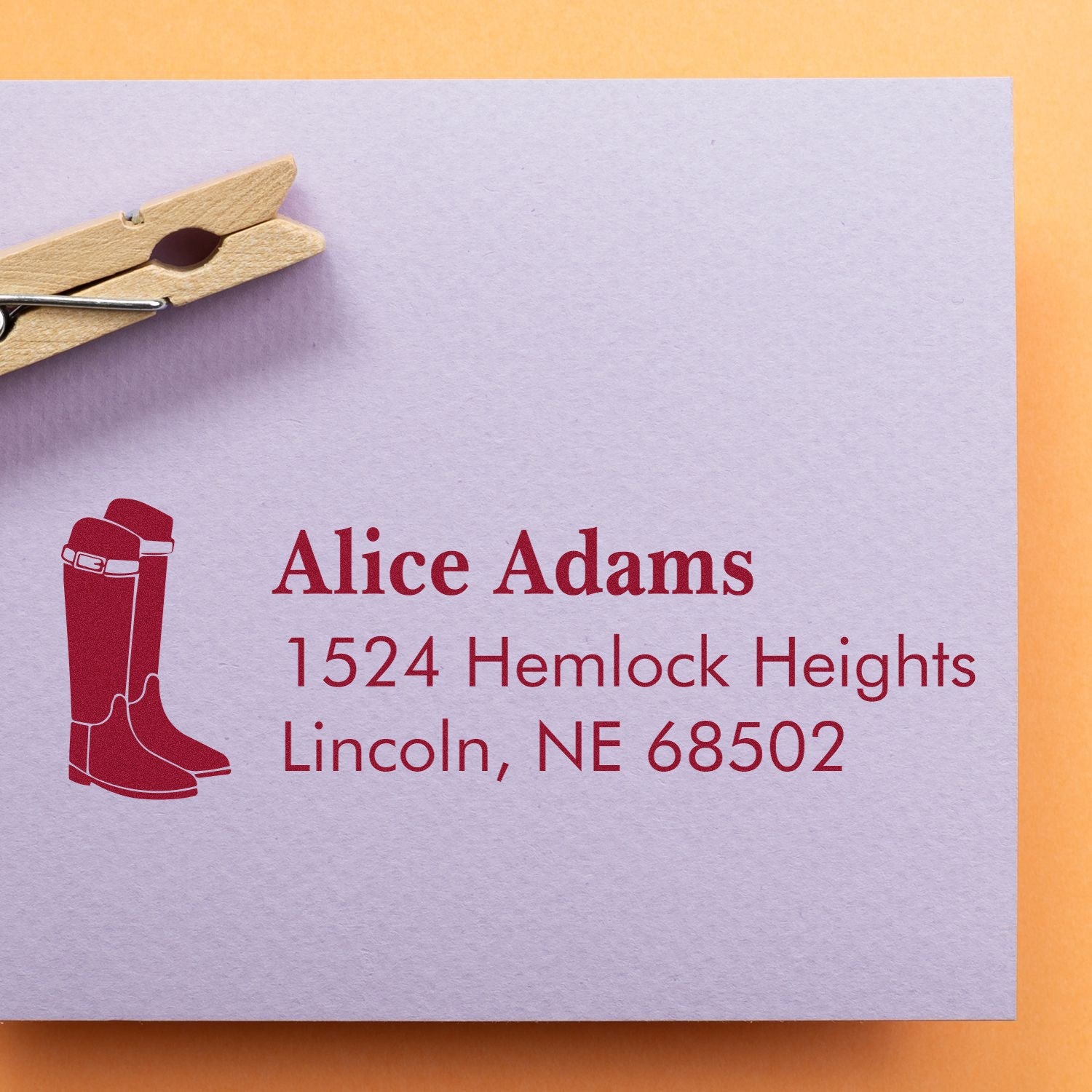 Custom rubber return address stamp with boots icon on envelope, featuring Alice Adams, Lincoln, NE 68502.