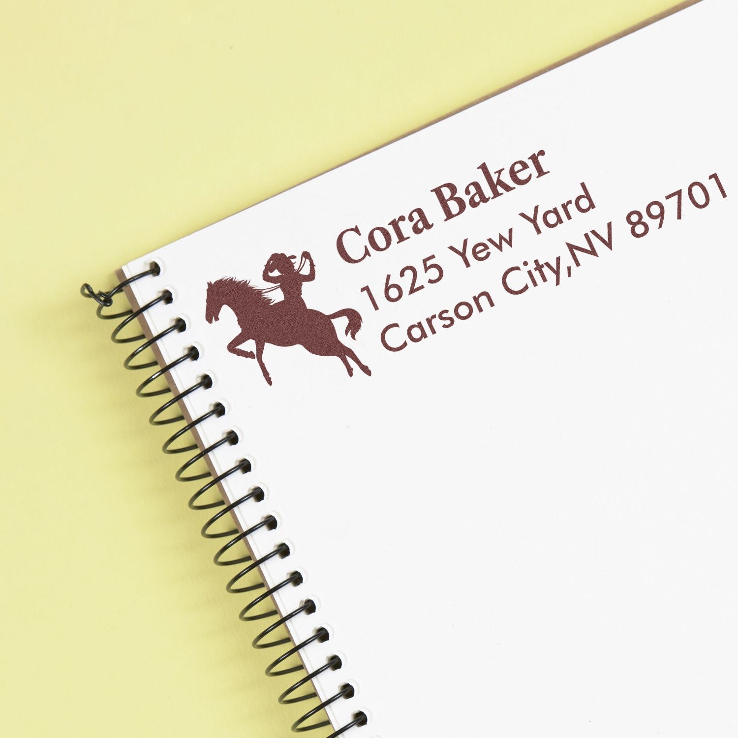 Custom equestrian return address rubber stamp for Cora Baker, Carson City, NV with horse rider logo.