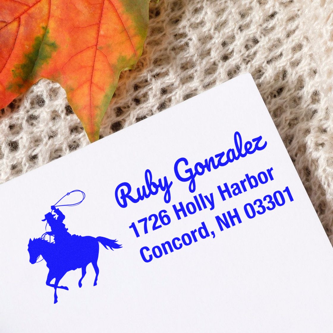 Personalized blue return address rubber stamp for Ruby Gonzalez, featuring horse and rider design and Concord, NH address.