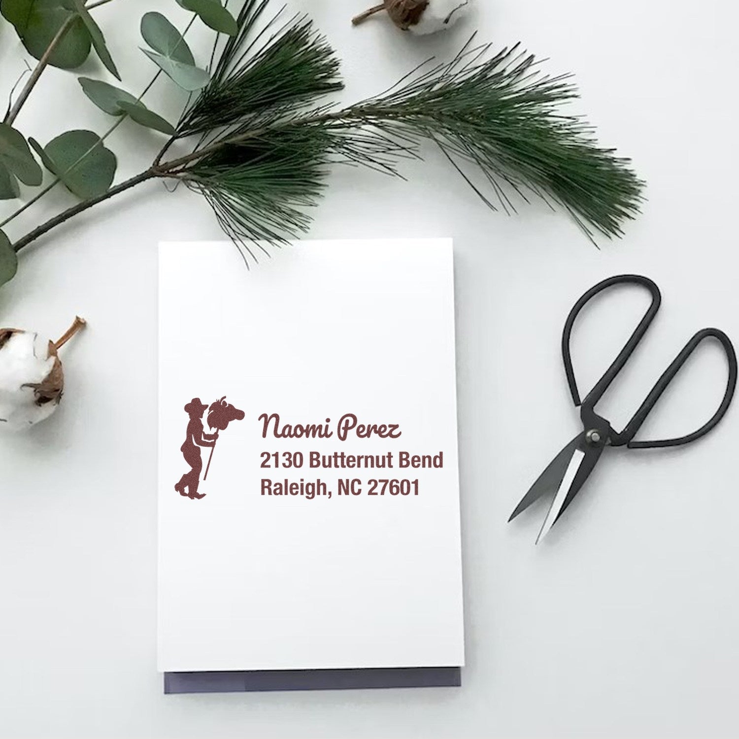 Personalized western return address rubber stamp with cowboy silhouette, name, and Raleigh, NC address on stationery.