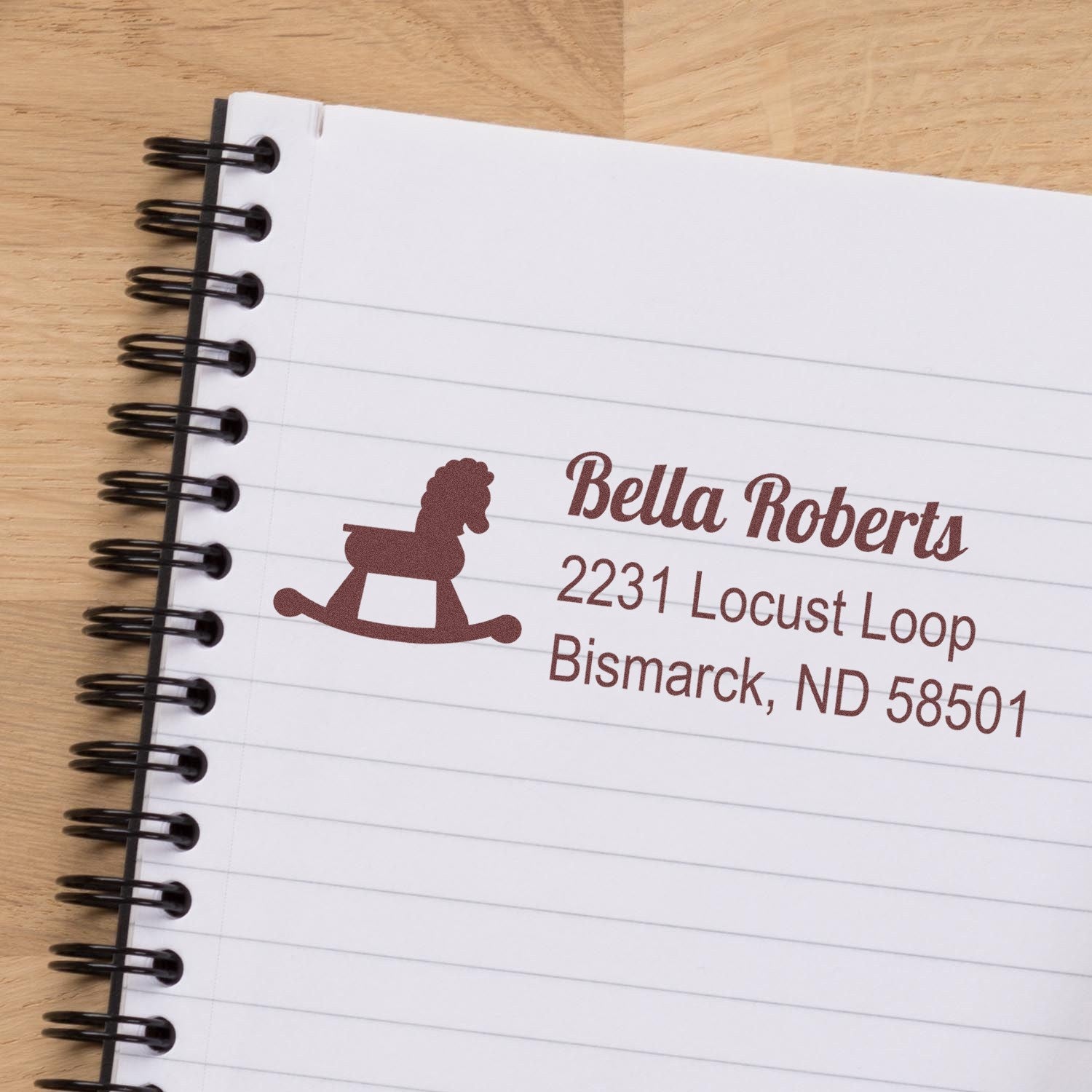 Custom return address rubber stamp with rocking horse logo for Bella Roberts in Bismarck, ND