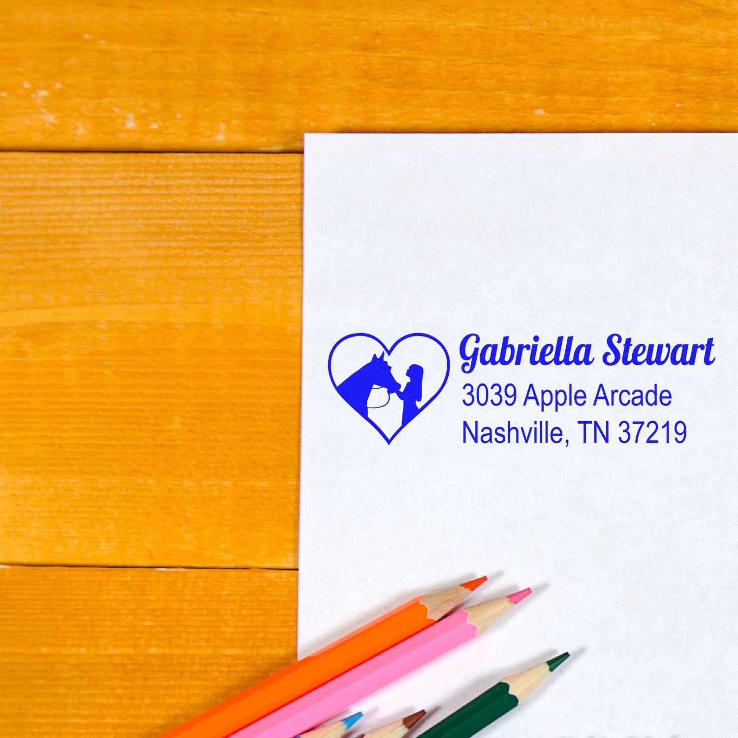 Custom rubber address stamp with heart horse logo, Gabriella Stewart name, and Nashville, TN return address on white paper.