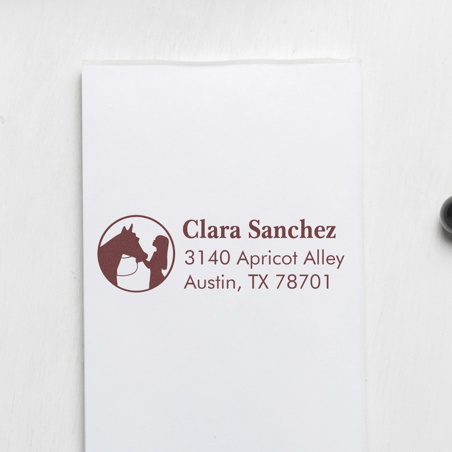 Custom horse and rider return address rubber stamp for Clara Sanchez, Austin TX 78701.