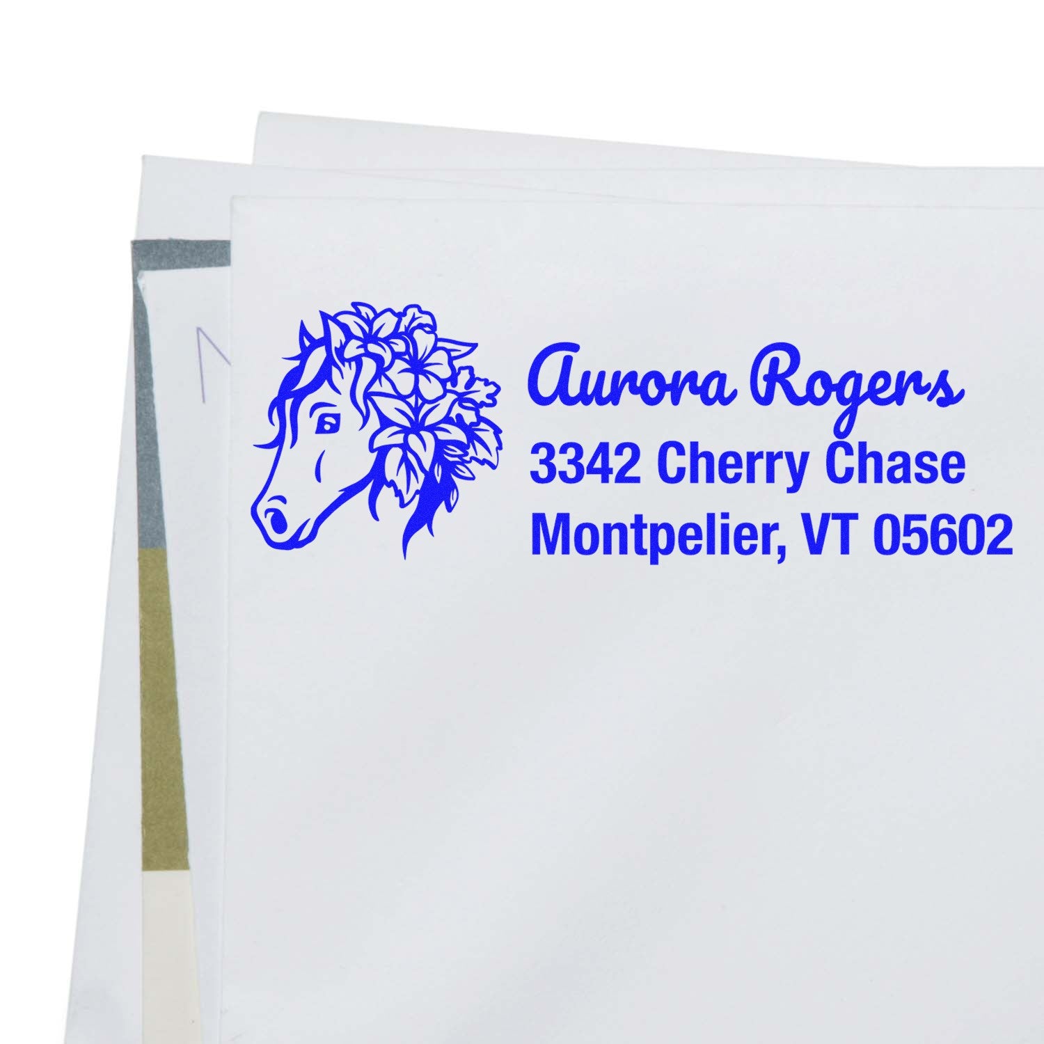 Personalized horse return address rubber stamp in blue ink on envelope with floral horse design, name, and address.
