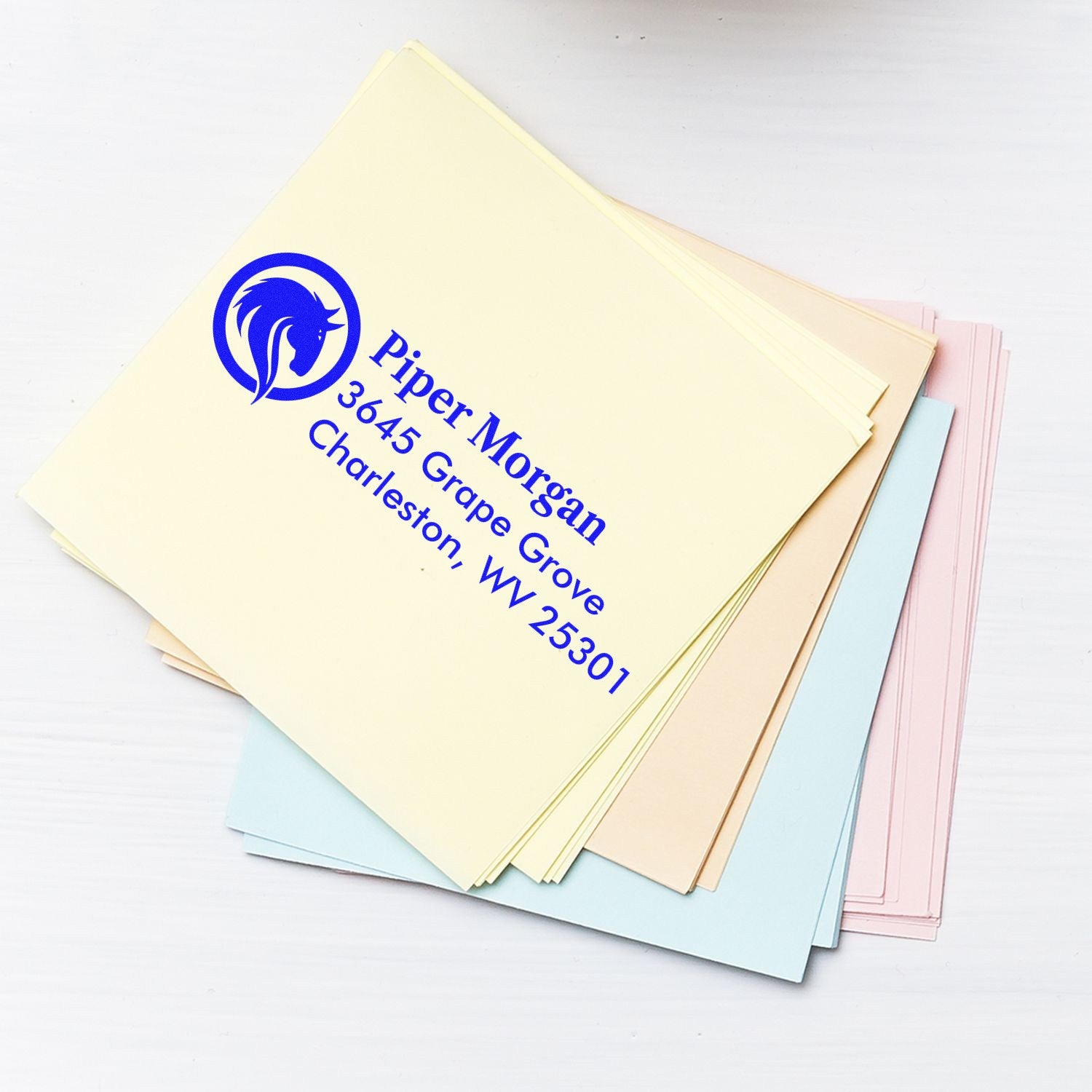 Custom return address rubber stamp with horse logo for Piper Morgan, Charleston, WV 25301 on pastel stationery