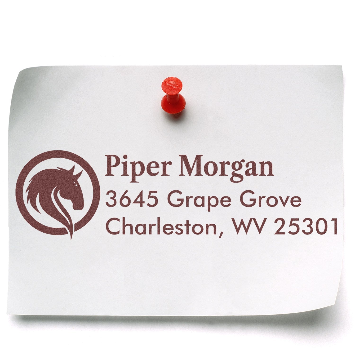 Custom return address rubber stamp with horse logo for Piper Morgan in Charleston, WV, stamped on pinned paper.
