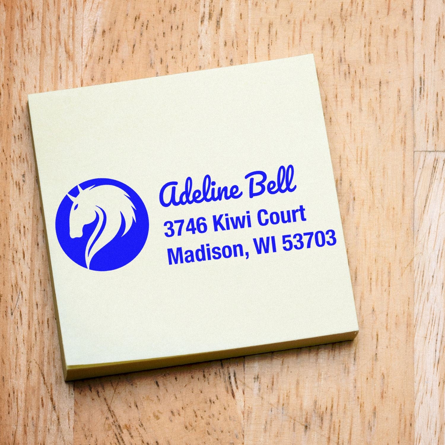 Blue custom return address rubber stamp with horse logo for Adeline Bell, Madison, WI.