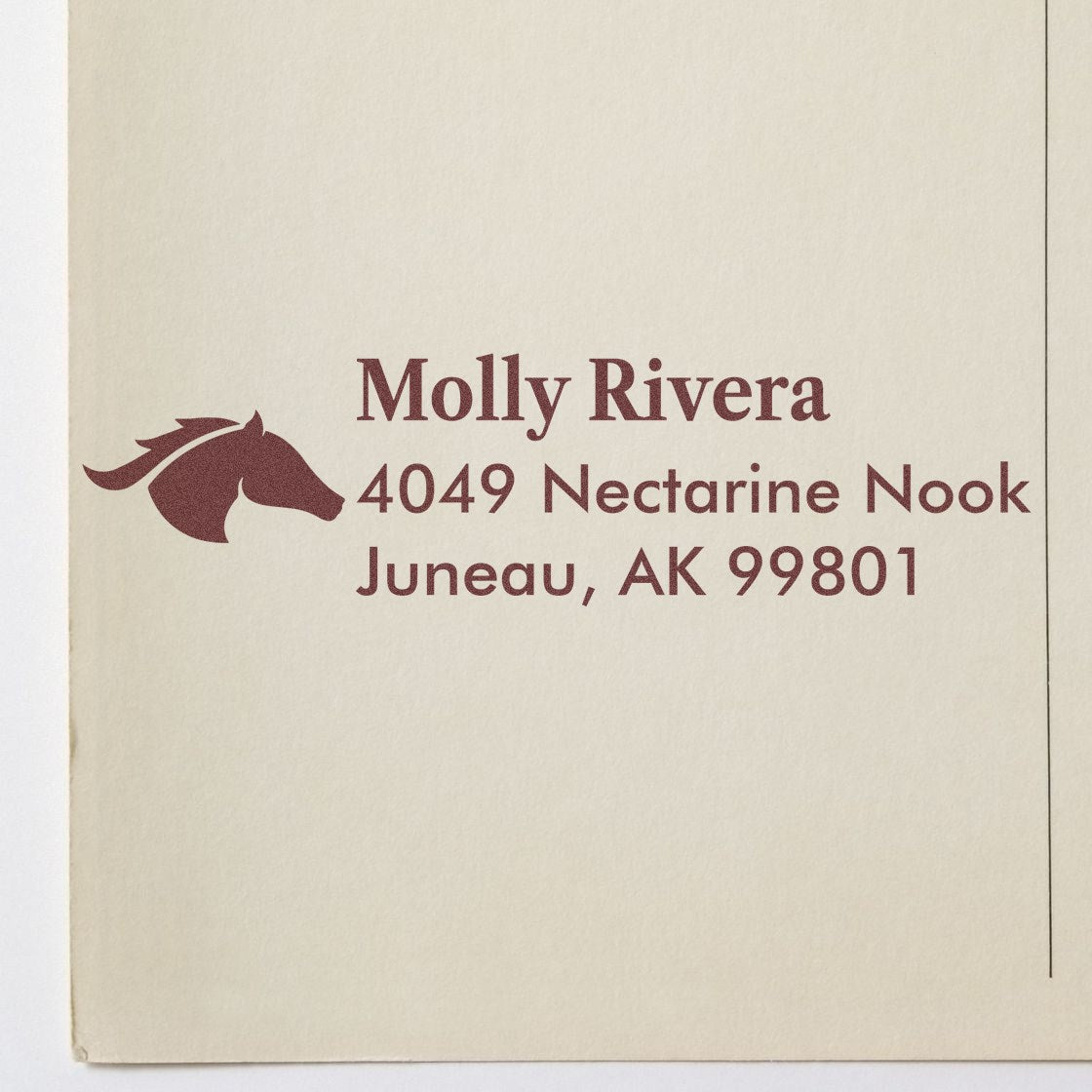 Custom address rubber stamp with horse logo for Molly Rivera, 4049 Nectarine Nook, Juneau, AK 99801.