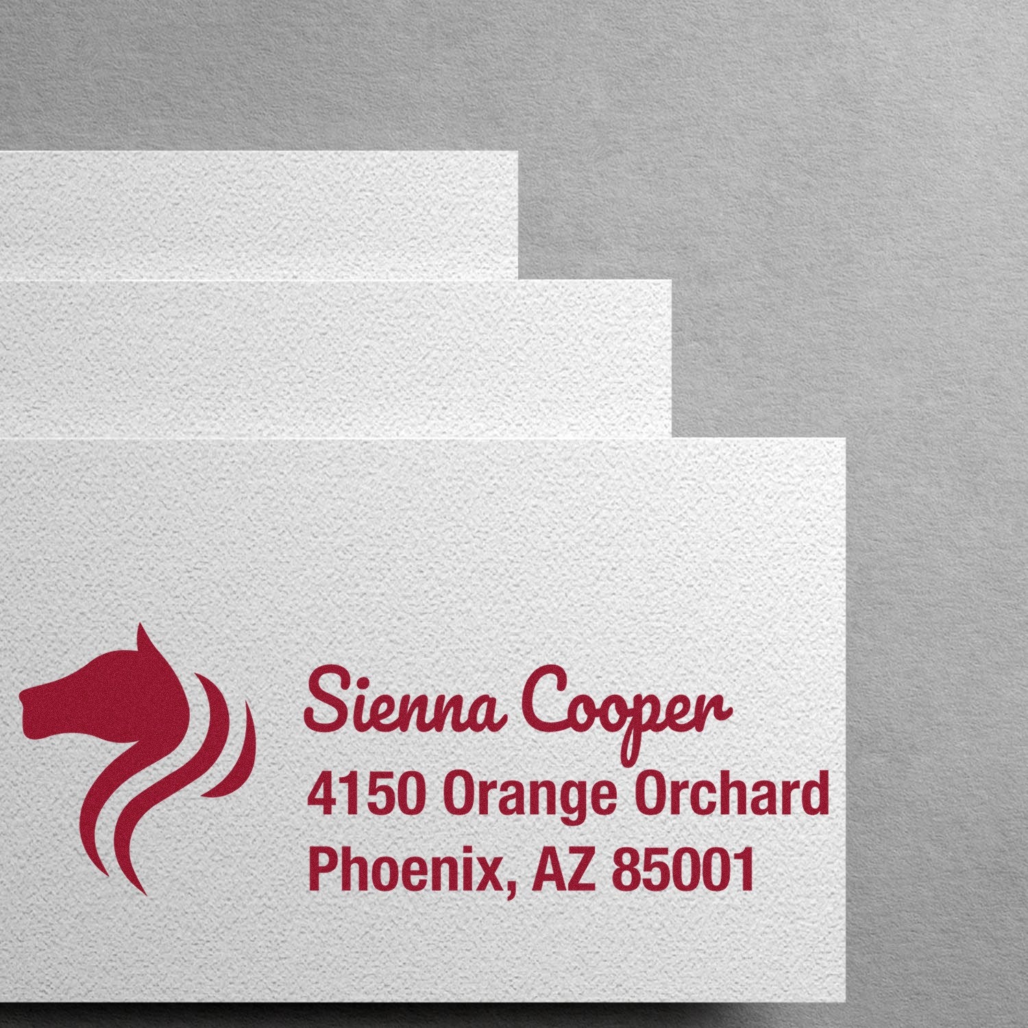 Custom rubber stamp mockup with horse logo and return address for Sienna Cooper, Phoenix, AZ.