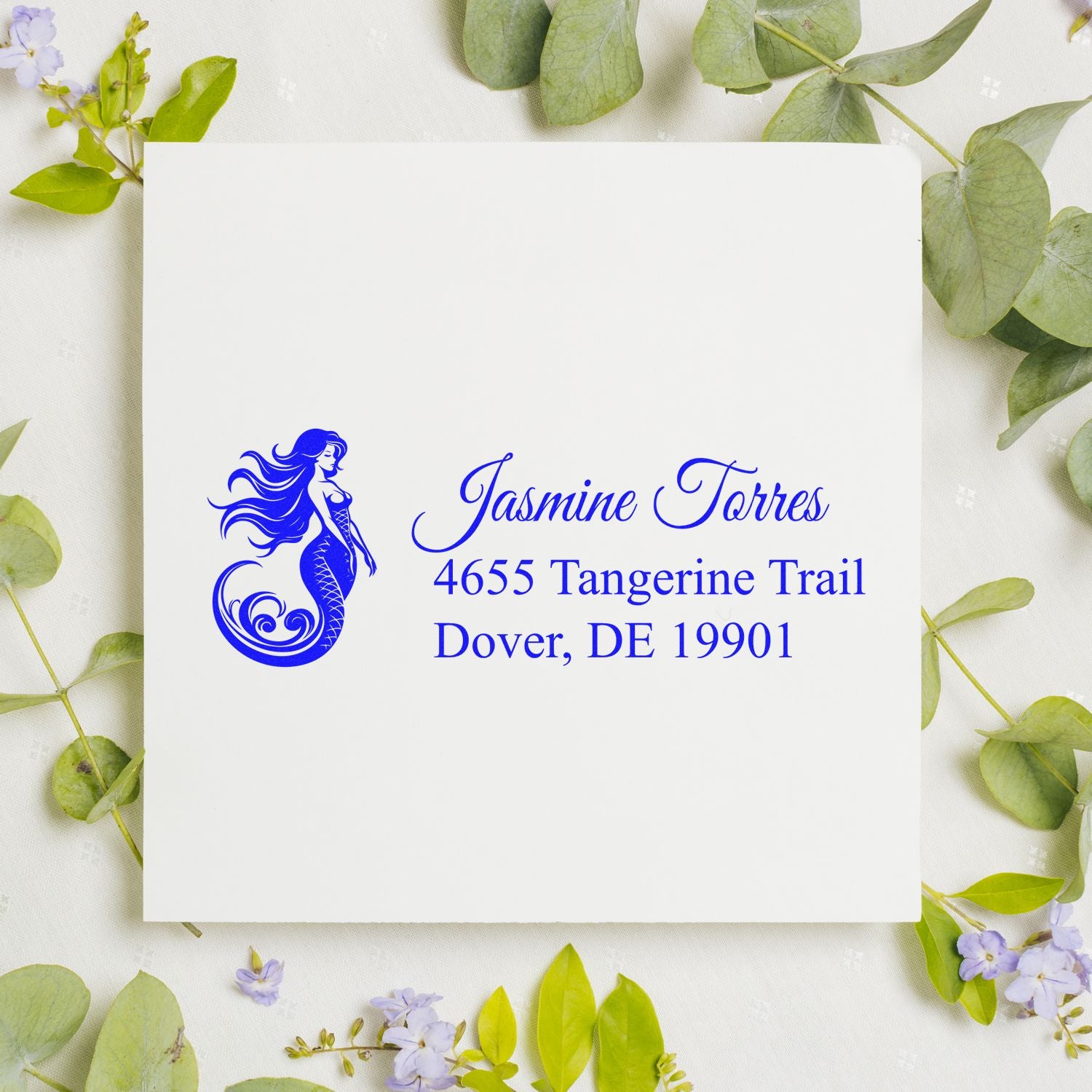Custom mermaid return address rubber stamp for Jasmine Torres, with Dover, DE mailing address in blue ink.