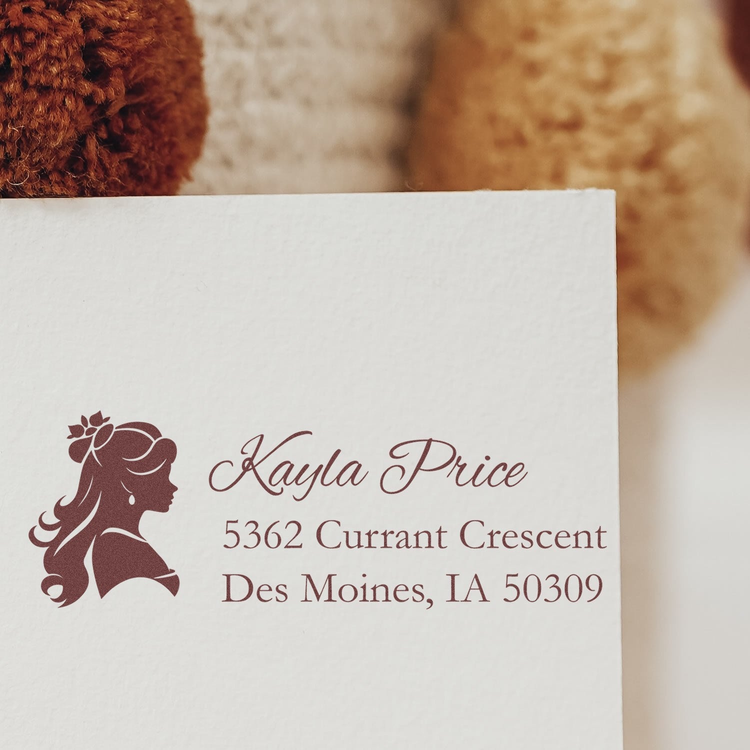 Custom return address rubber stamp with woman silhouette, Kayla Price, Des Moines, IA 50309.