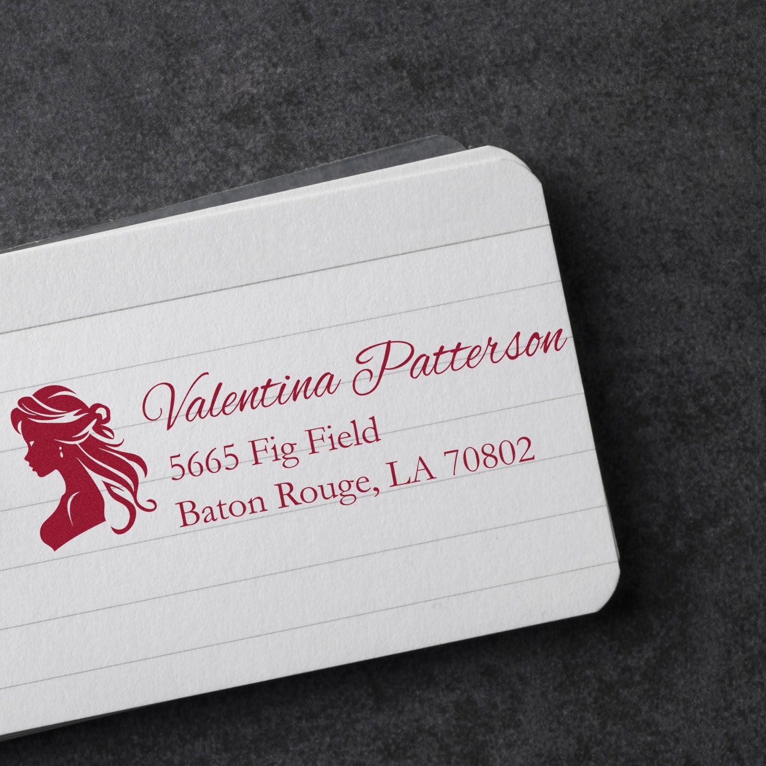Custom return address rubber stamp with woman silhouette logo, ideal for personalized stationery and business mail.