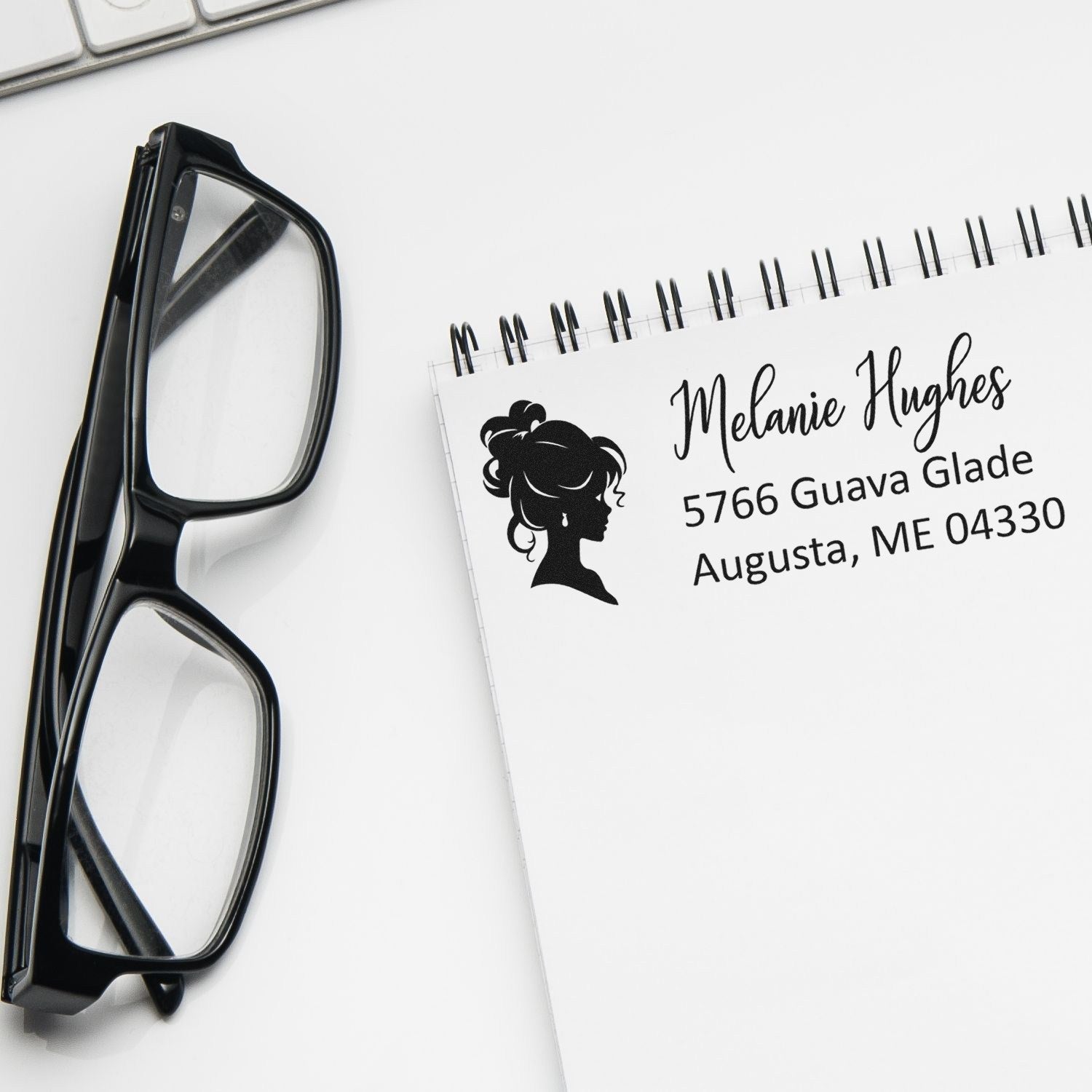 Personalized return address rubber stamp with woman silhouette on notepad, ideal for mailing labels and envelopes.