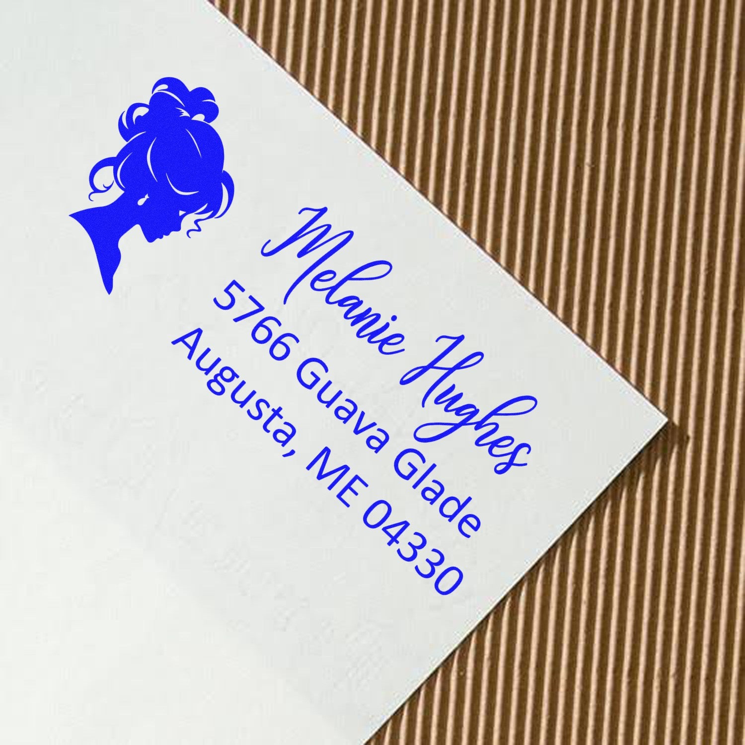 Custom return address rubber stamp with female silhouette for Melanie Hughes, Augusta, ME 04330