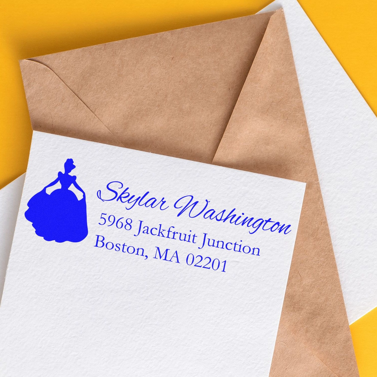 Custom return address rubber stamp on envelope and stationery with blue princess silhouette design for mailing.